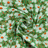 Popeline de coton imprimée pois corail et fleurs orange fond vert