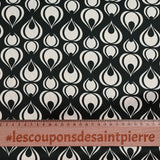 Polyester satin crepe printed tears of the ecru peacock black background