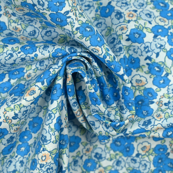 Popeline de coton imprimée champs de fleurs bleu