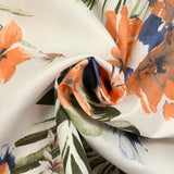 Coton imprimé élasthanne Hawaii orange et bleu fond blanc