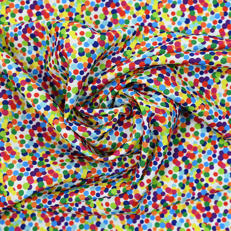 Tissu carnaval polyester mini pois multicolore fond blanc
