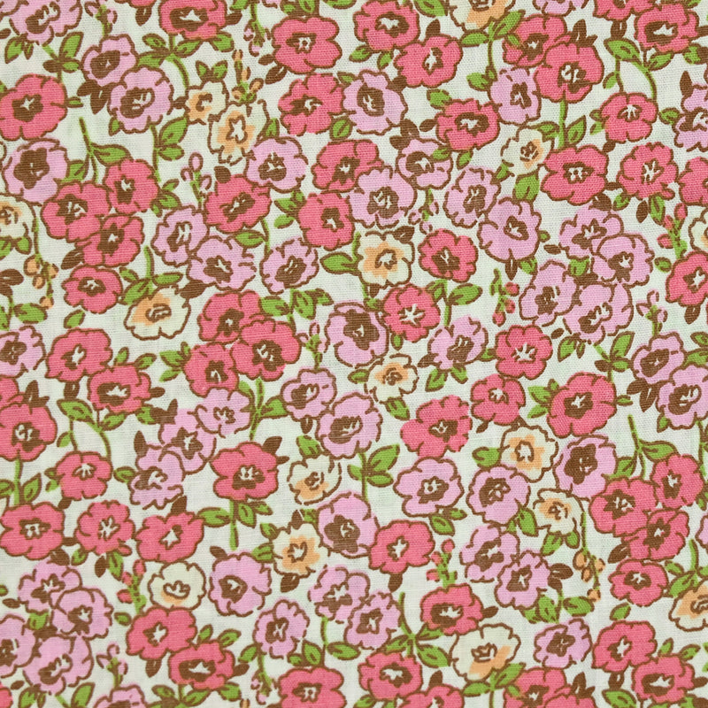 Popeline de coton imprimée champs de fleurs rose