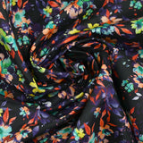 Coton imprimé fleuri graphique orange et violet fond noir