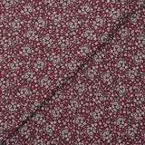Crêpe viscose imprimé petites fleurs blanches fond bordeaux foncé