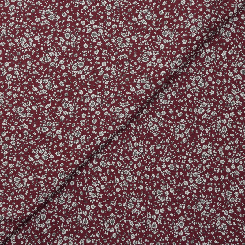 Crêpe viscose imprimé petites fleurs blanches fond bordeaux foncé