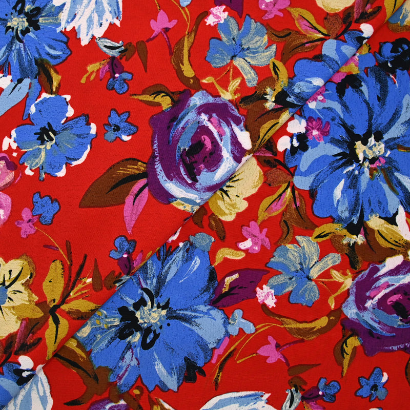 Crépon polyester jolie pivoine bleu fond rouge