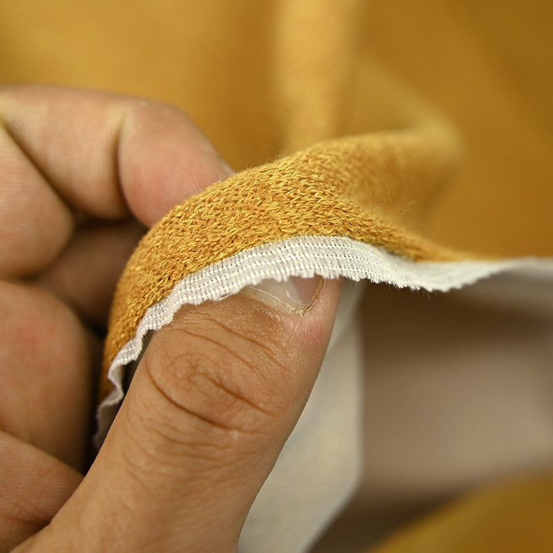 Maille polyester moutarde envers contrecollé