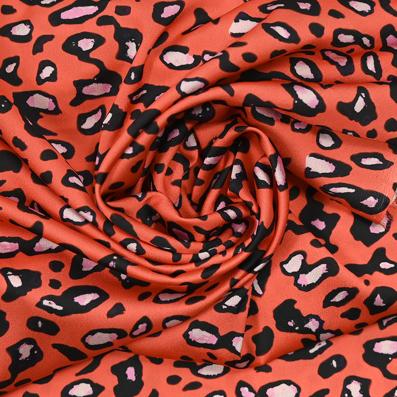 Crêpe satin polyester imprimé safari fond orange corail