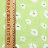 Double gauze printed with daisy smiley face, apple green background