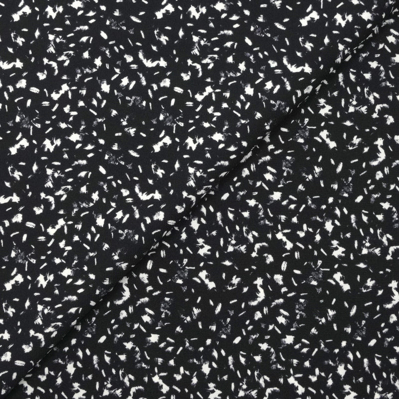 Crêpe polyester imprimé graphique taches blanches fond noir
