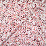 Coton imprimé ouragan floral rose fond blanc