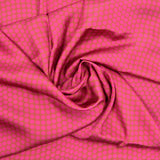 Crêpe satin polyester imprimé pois rose fond cuivre