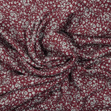 Crêpe viscose imprimé petites fleurs blanches fond bordeaux foncé