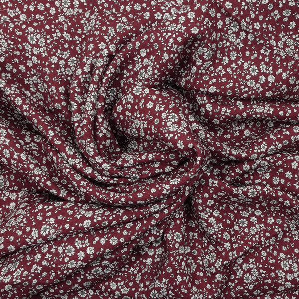 Crêpe viscose imprimé petites fleurs blanches fond bordeaux foncé