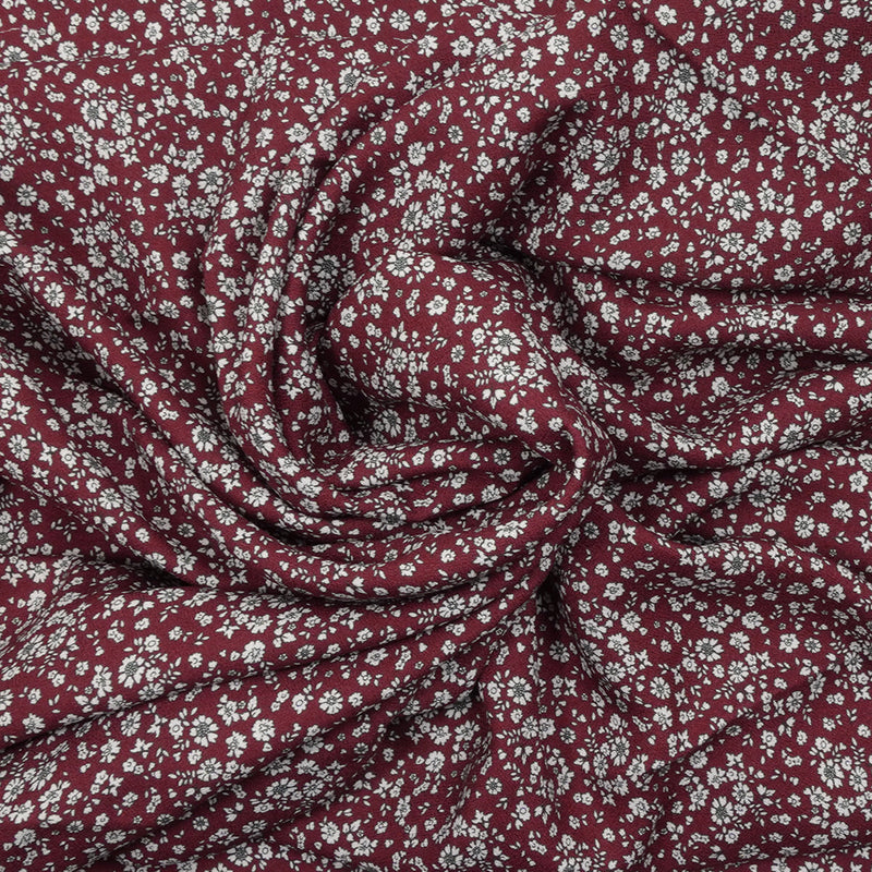 Crêpe viscose imprimé petites fleurs blanches fond bordeaux foncé