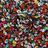 Crépon polyester fleuri multicolore fond noir
