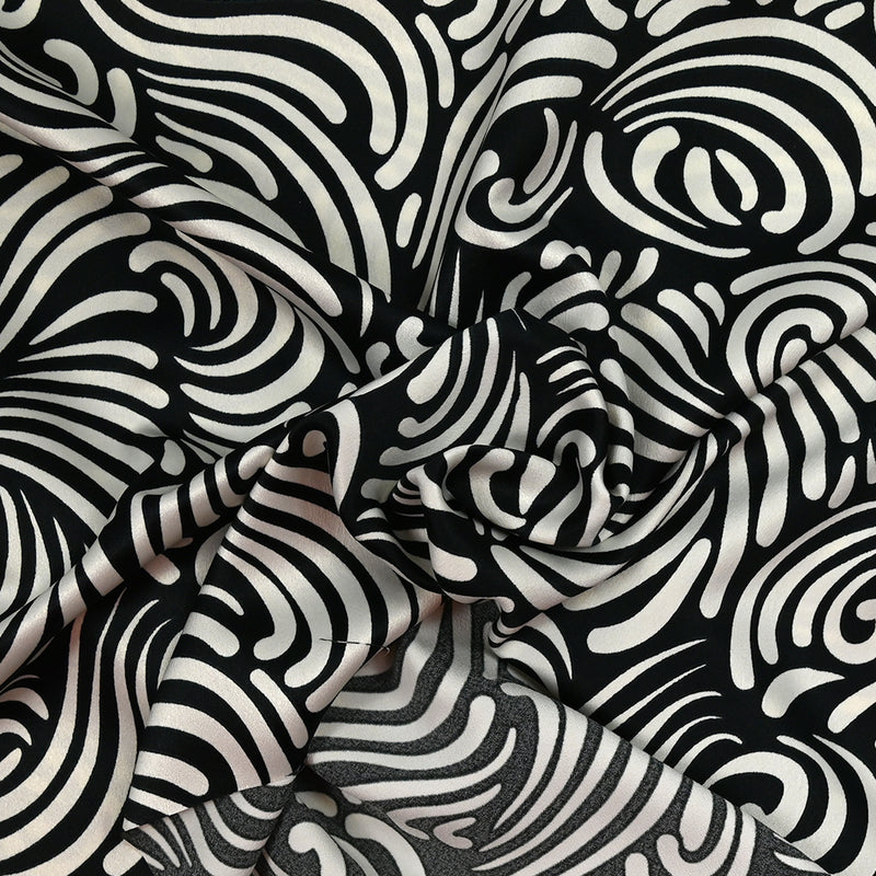 Crêpe satin polyester imprimé l'enfant des dunes blanc cassé fond noir