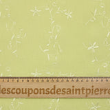 Voile de polyester brodé fleurs et feuillages vert anis