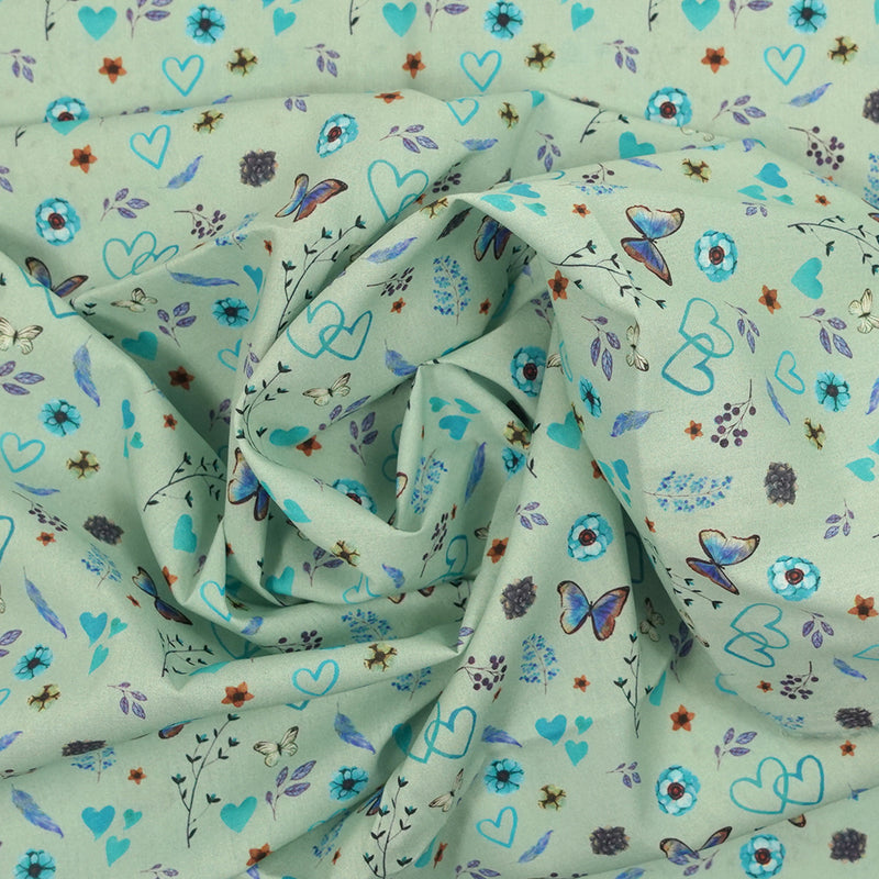 Coton imprimé cœur et papillon fond vert blanc