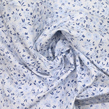 Piqué de coton imprimé fleurs de saison bleu fond blanc