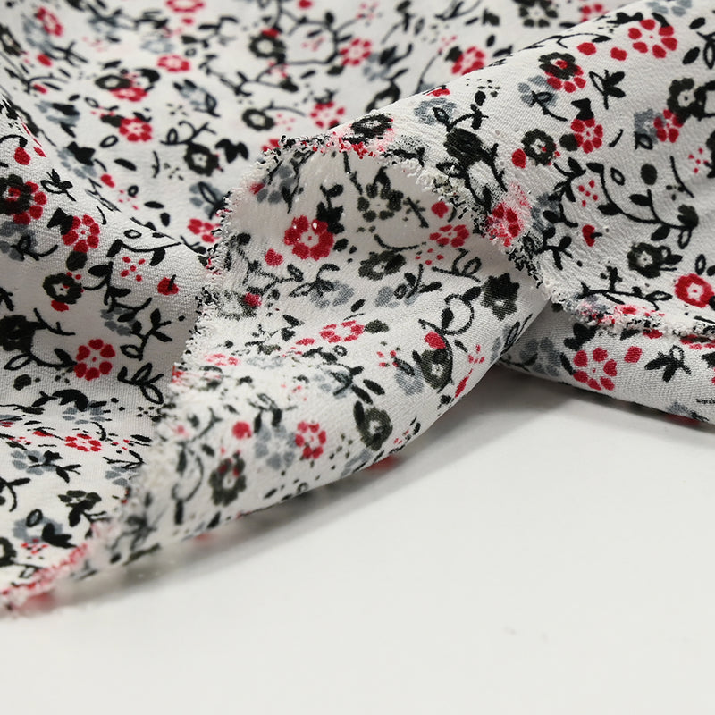 Crêpe de polyester imprimé mini fleurs noir et rouge fond blanc