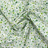 Coton imprimé ouragan floral vert fond blanc