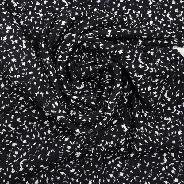 Crêpe polyester imprimé graphique taches blanches fond noir