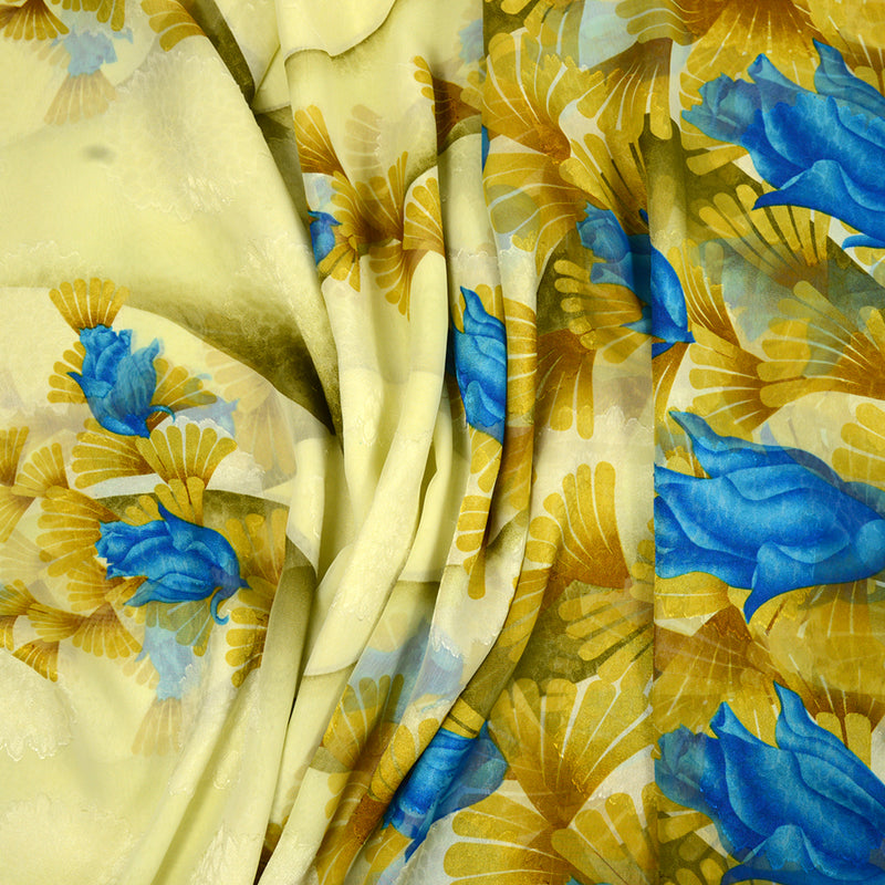 Mousseline polyester imprimée fleurs bleus et dorés fond jaune