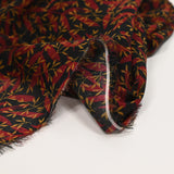 Mousseline imprimée feuilles rouge et ocre fond noir