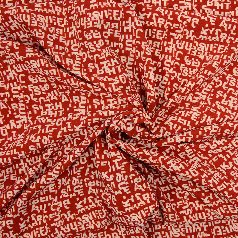 Crêpe polyester imprimé lettre fond rouille
