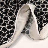 Jersey polyester écailles fond noir