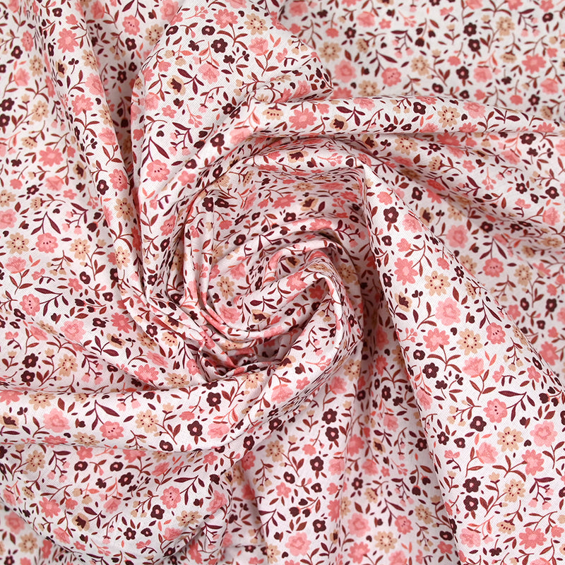 Coton imprimé ouragan floral rose fond blanc