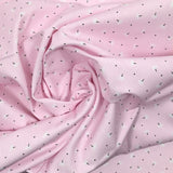 Piqué de coton imprimé pissenlit fond rose clair