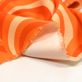 Crêpe lourd de polyester élasthanne imprimé disco orange
