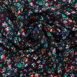Crêpe viscose imprimé fleurs éclatantes vertes et orange fond noir