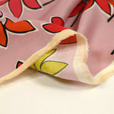 Coton satiné imprimé fleurs naïves orange fond rose