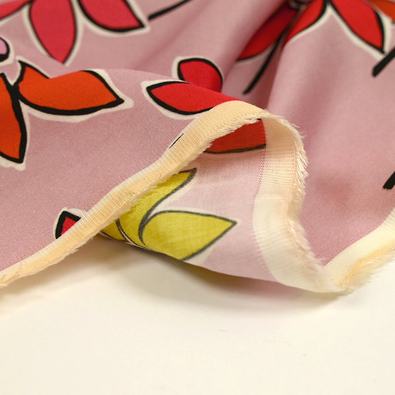 Coton satiné imprimé fleurs naïves orange fond rose