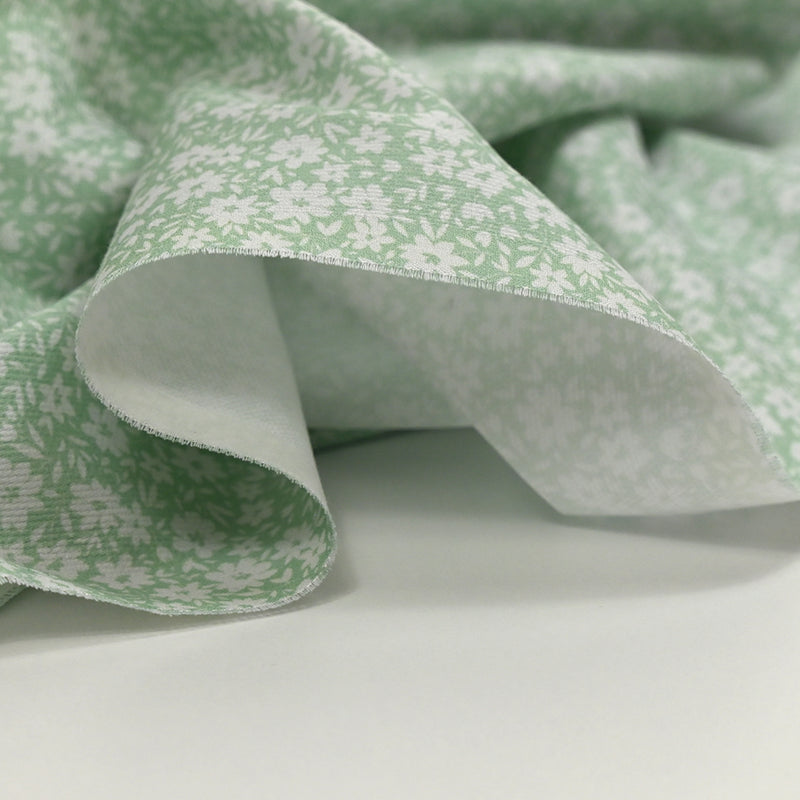 Piqué de coton imprimé fleurs printanière fond vert