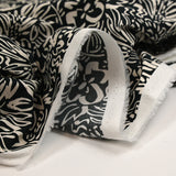 Coton imprimé croquis fleurs blanc fond noir