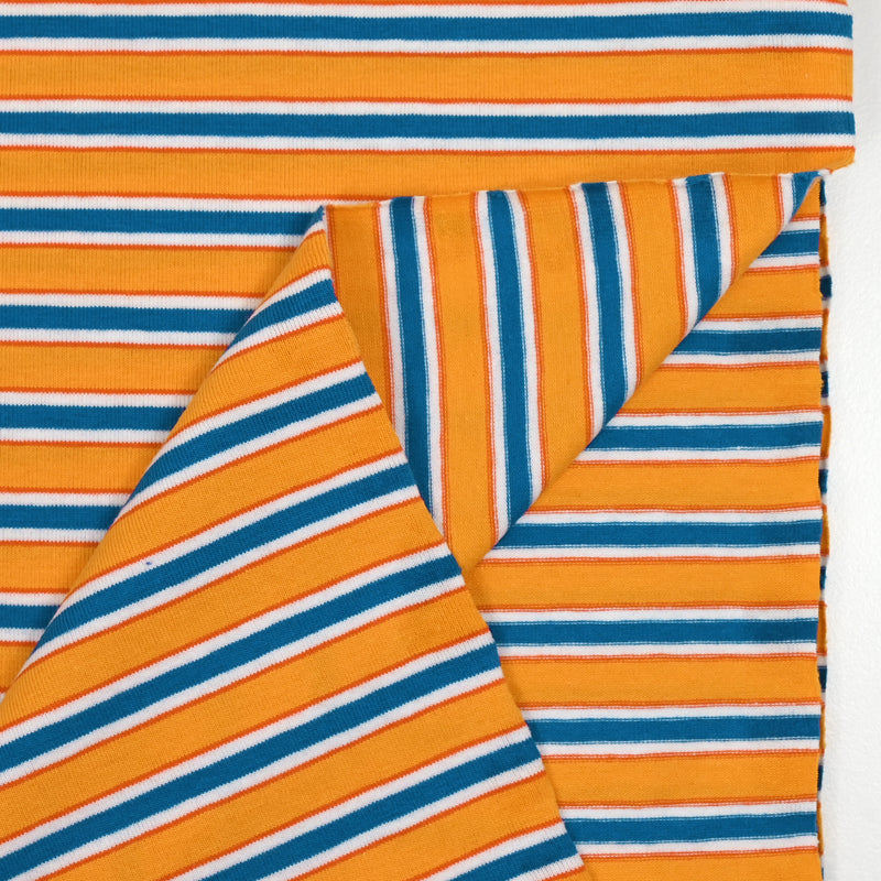 Rayas azules de jersey de algodón y fondo de sol amarillo naranja