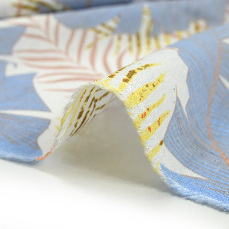 Light printed viscose Light sheets and blue feathers white background