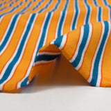 Cotton jersey Blue stripes and orange yellow sun background