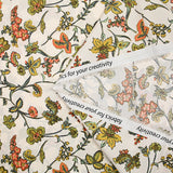 Cotton poplin digitally printed with coral and olive Indian flowers on an ecru background
