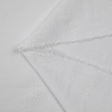 Crêpe polyester floqué fleurs ton sur ton fond blanc