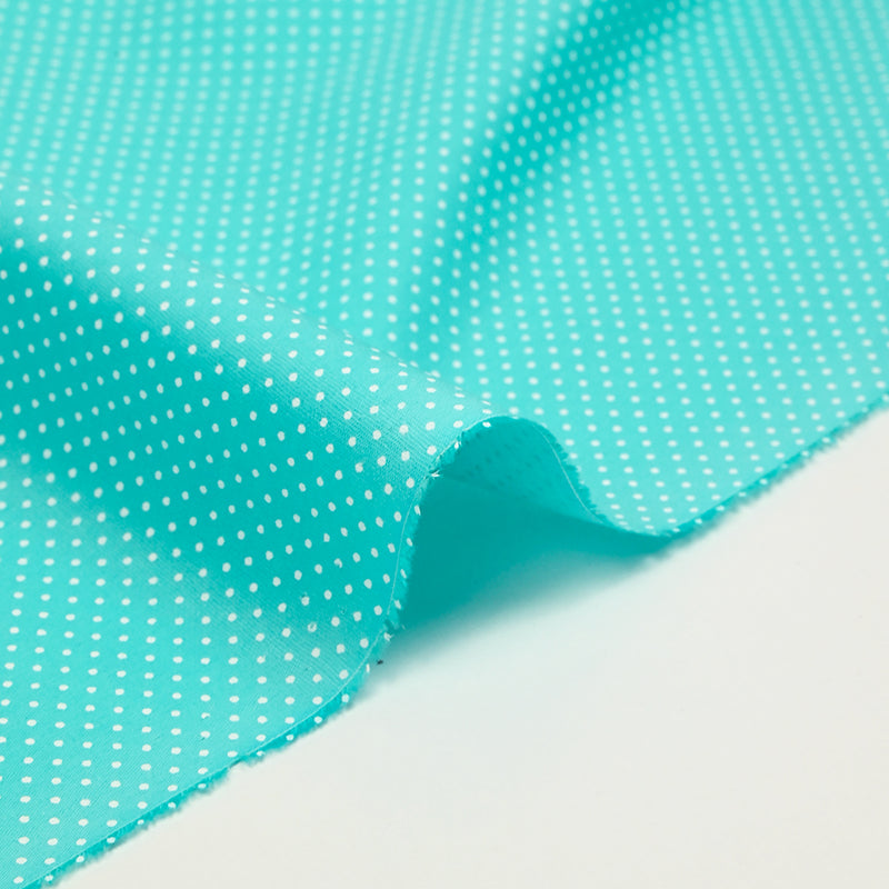 Coton imprimé pois 1mm fond bleu turquoise