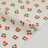 Jersey pointelle coton imprimé cerise fond blanc cassé