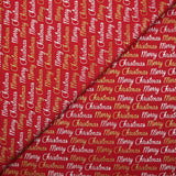 Popelina de algodón estampada con Feliz Navidad en dorado y plateado sobre fondo rojo