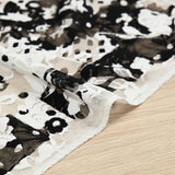 Dentelle polyester imprimée fantaisie noir sur fond blanc