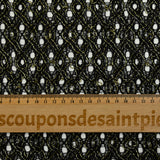 Dentelle polyester ajourée à entrelacs de lurex doré fond noir