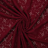 Maille polyester ajourée fleurs fond bordeaux